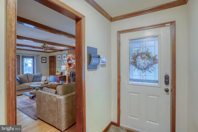 a living room with furniture and a painting on the wall