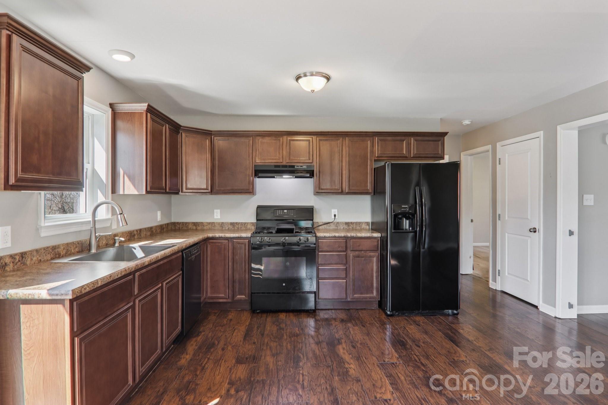751 Hutch Mountain Road Fletcher, NC 28732 - Photo 13 of 48 a kitchen with a refrigerator stove top oven and sink