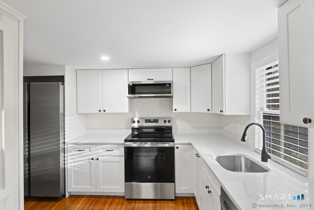 3 Riverside Road, Unit B Newtown, CT 06482 - Photo 5 of 20 a kitchen with granite countertop a sink stove and refrigerator