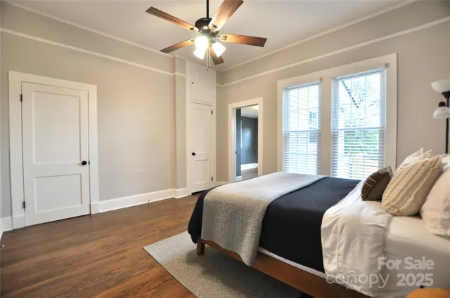 a bedroom with a large bed and a ceiling fan