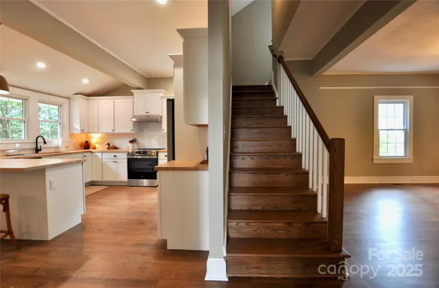 a kitchen with cabinets and wooden floors