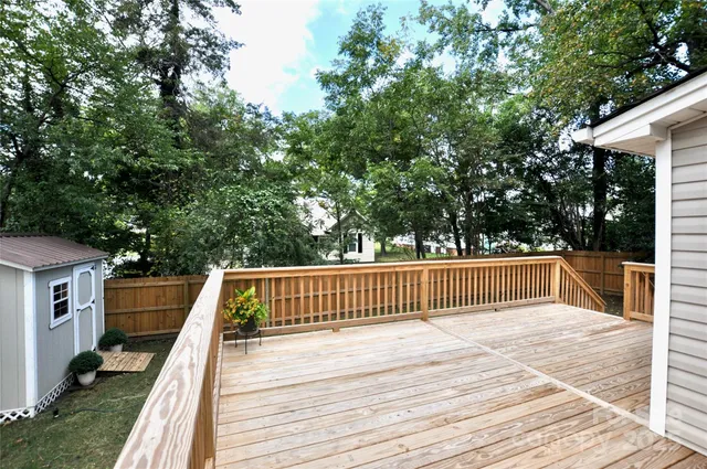 a view of balcony with wooden floor and fence