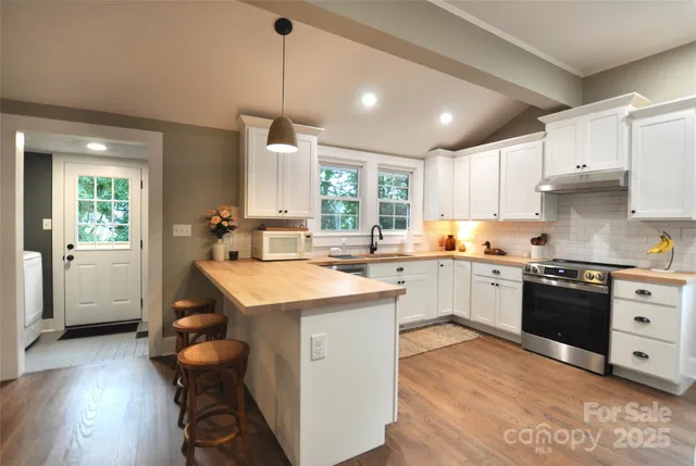 a kitchen with a sink appliances and cabinets