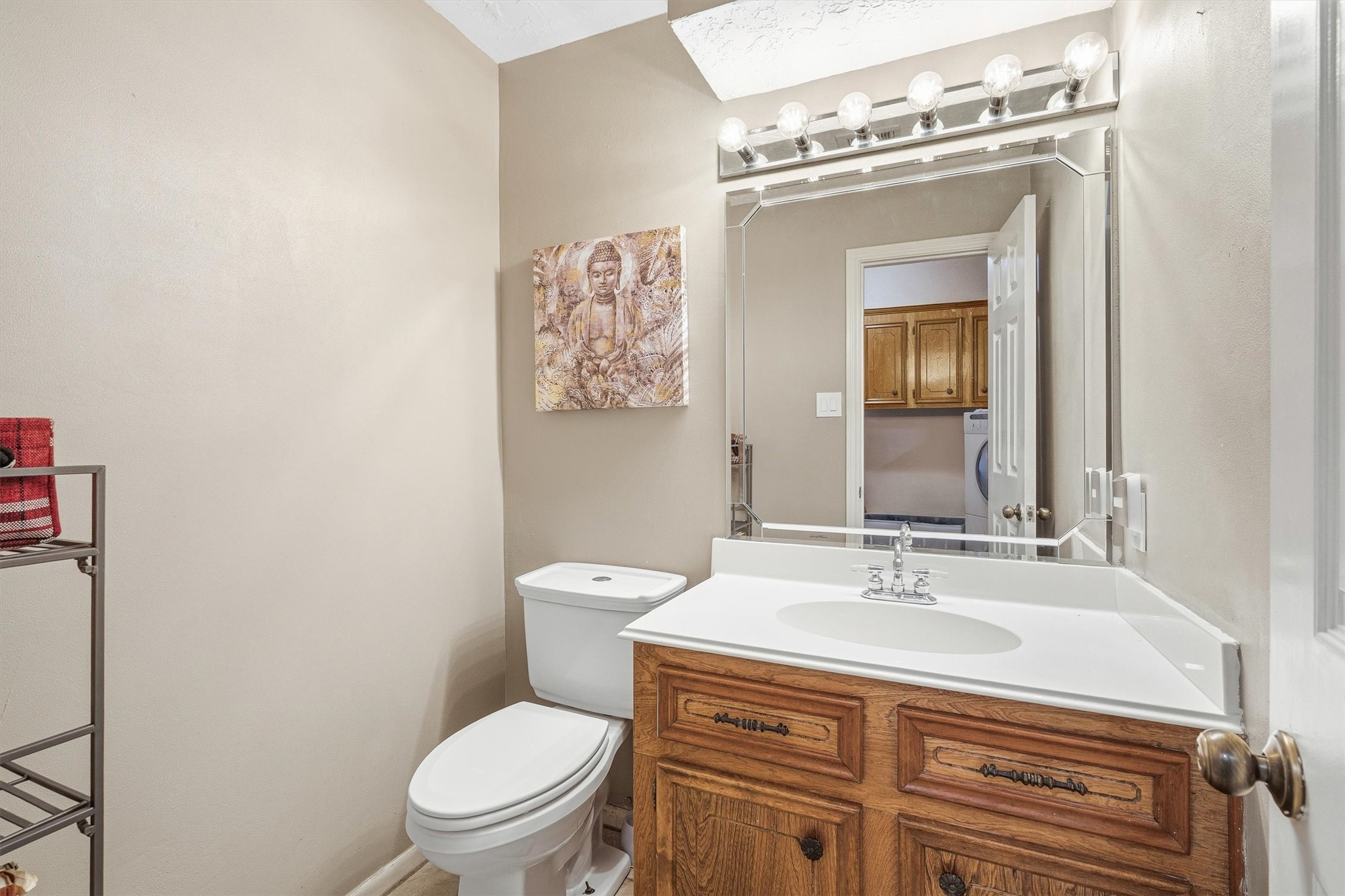 826 North Rivershire Drive Conroe, TX 77304 - Photo 30 of 46 The half bath checks all the boxes. Single vanity, cultured marble countertop, wood cabinetry, and a convenient location off the main living area.