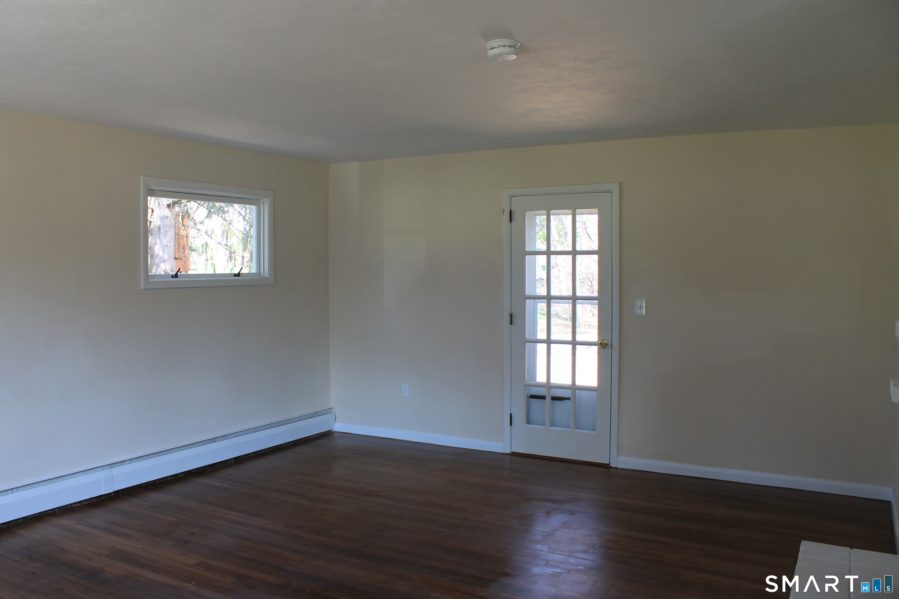 134 Sunset Street Windsor Locks, CT 06096 - Photo 17 of 23 an empty room with wooden floor and windows