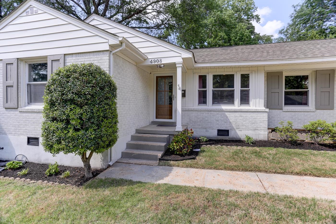 4908 Mockingbird Lane Memphis, TN 38117 - Photo 2 of 21 a front view of a house with garden