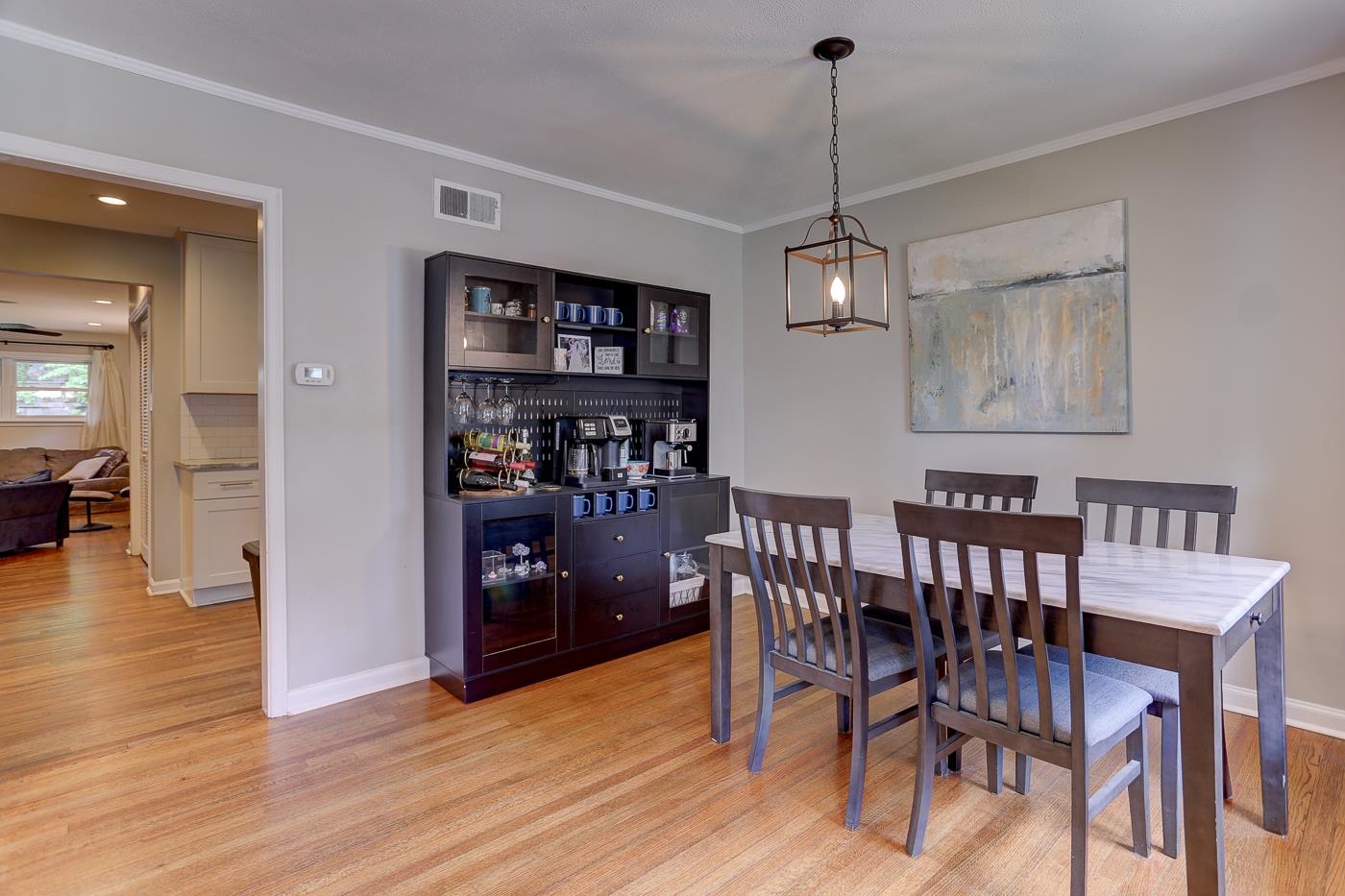 4908 Mockingbird Lane Memphis, TN 38117 - Photo 6 of 21 a view of a dining room with furniture wooden floor and a chandelier