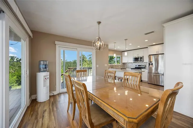 a dining room with furniture and wooden floor