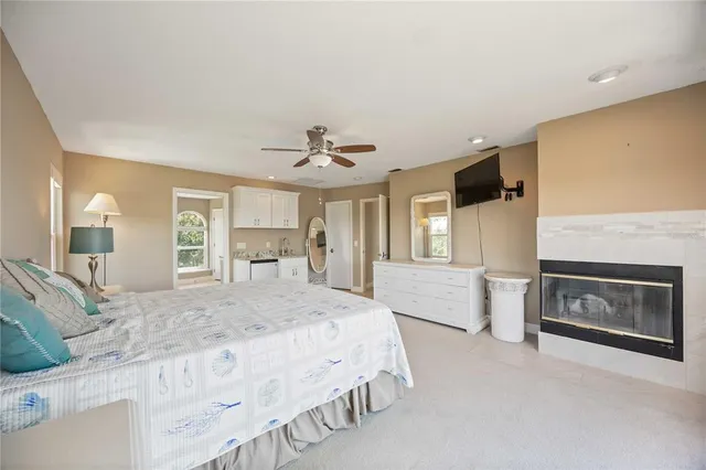 a spacious bedroom with a bed a chandelier and closet