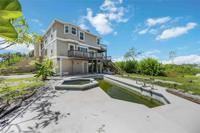 a swimming pool with outdoor seating and yard