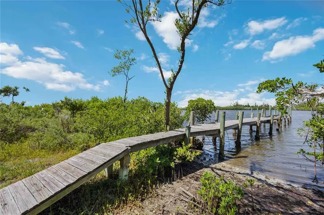 an aerial view of a house with a yard and lake view
