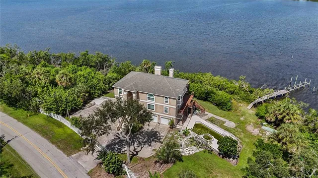 an aerial view of a house with a lake view