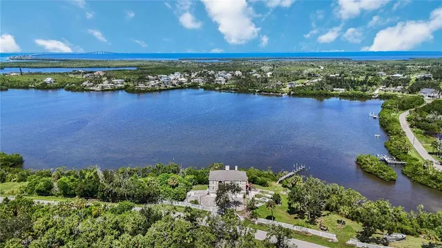 an aerial view of a house with a yard and lake view