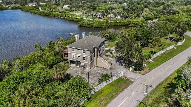 an aerial view of a house with a yard