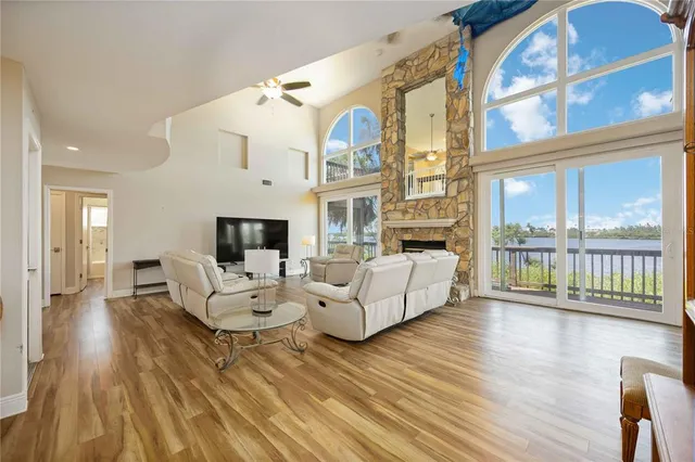 a living room with fireplace furniture and a large window