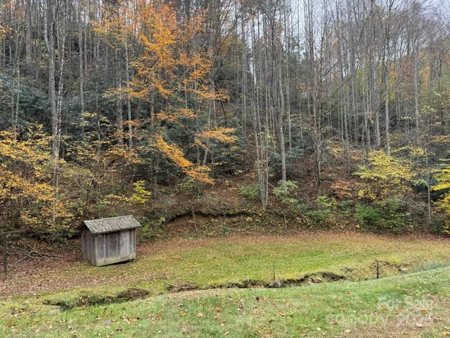 a view of a wooden door and a yard