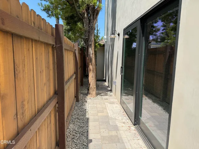 a bathroom with a glass door shower and sink