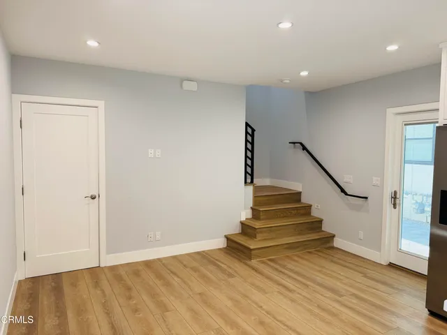 a view of entryway and hall with wooden floor