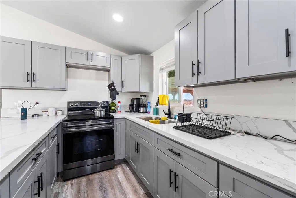 11772 Middleton Road Phelan, CA 92371 - Photo 11 of 40 a kitchen with a sink white cabinets and stainless steel appliances