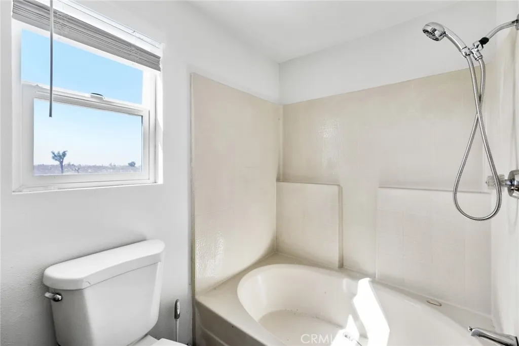 11772 Middleton Road Phelan, CA 92371 - Photo 22 of 40 a white toilet sitting next to a bathroom sink