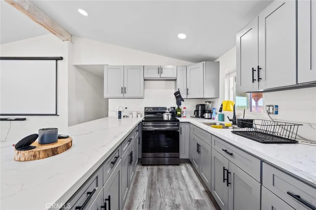 11772 Middleton Road Phelan, CA 92371 - Photo 10 of 40 a kitchen with a sink stove and cabinets