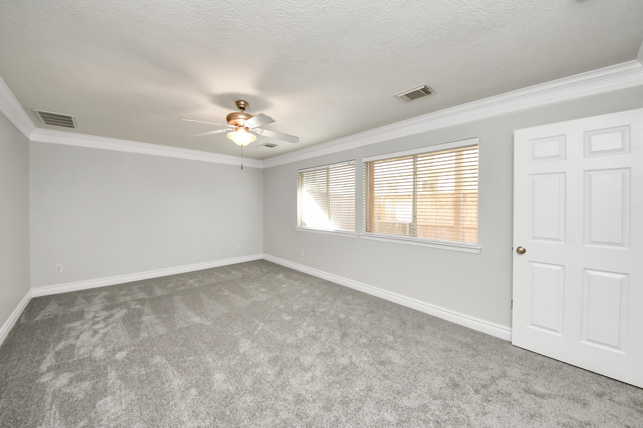 5909 Katy Street Houston, TX 77007 - Photo 20 of 34 Spacious primary bedroom with ceiling fan, and ample natural light from the windows.