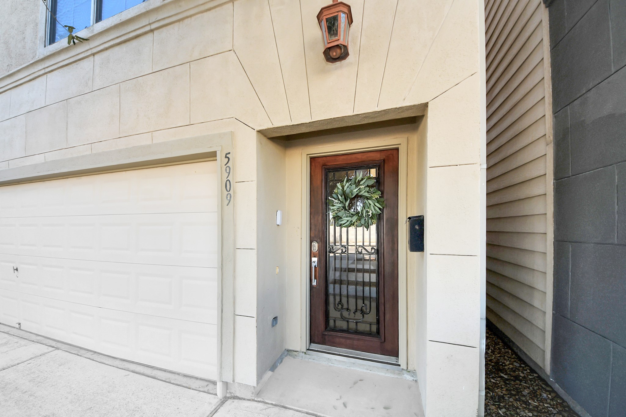 5909 Katy Street Houston, TX 77007 - Photo 2 of 34 A covered entryway featuring a stylish wooden door with decorative glass and a private mailbox.