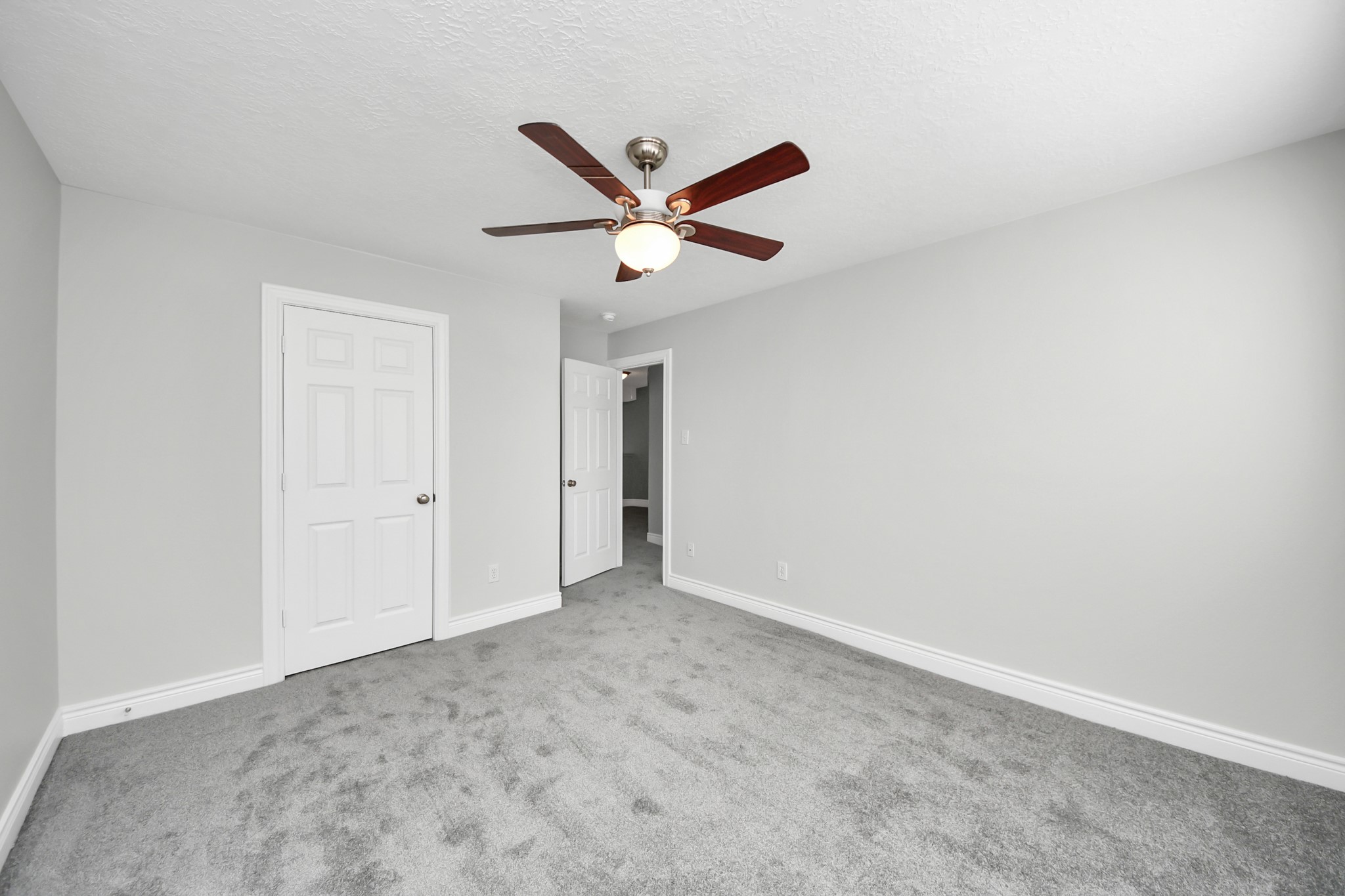 5909 Katy Street Houston, TX 77007 - Photo 29 of 34 Bedroom with neutral newly painted walls, plush new carpet, and a ceiling fan.