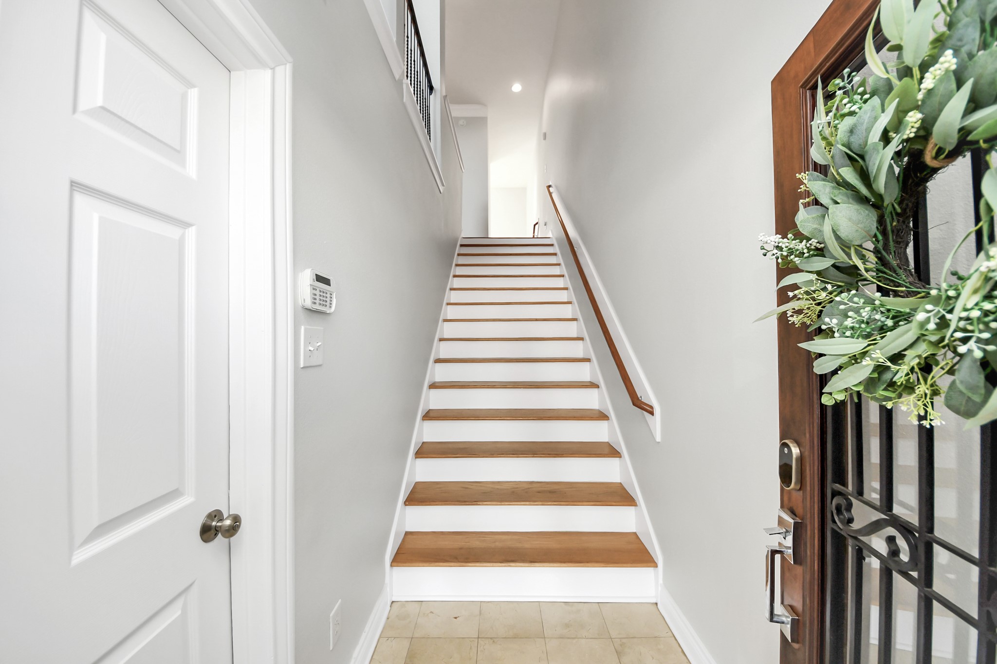 5909 Katy Street Houston, TX 77007 - Photo 3 of 34 Welcoming entryway features a staircase with wooden treads and white risers.