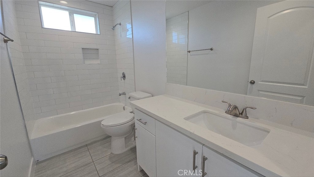 10413 Avalon Boulevard Los Angeles, CA 90003 - Photo 12 of 23 a bathroom with a sink a toilet and shower