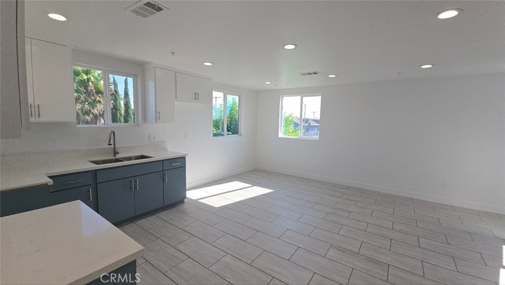 10413 Avalon Boulevard Los Angeles, CA 90003 - Photo 14 of 23 a kitchen with stainless steel appliances granite countertop a sink a stove and a window