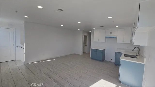 a kitchen with a sink and cabinets