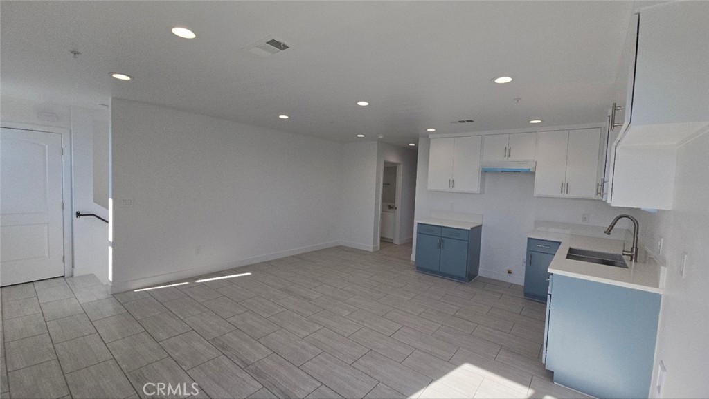 10413 Avalon Boulevard Los Angeles, CA 90003 - Photo 15 of 23 a kitchen with kitchen island granite countertop a sink and refrigerator