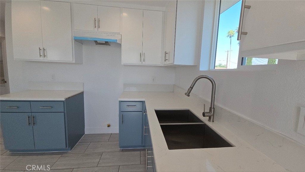 10413 Avalon Boulevard Los Angeles, CA 90003 - Photo 16 of 23 a kitchen with a sink and cabinets