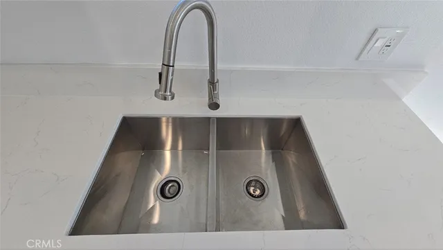 a kitchen with a sink window and cabinets