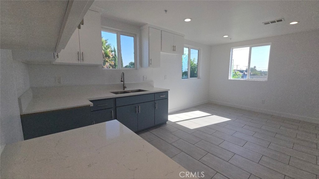 10413 Avalon Boulevard Los Angeles, CA 90003 - Photo 20 of 23 a kitchen with a sink window and cabinets