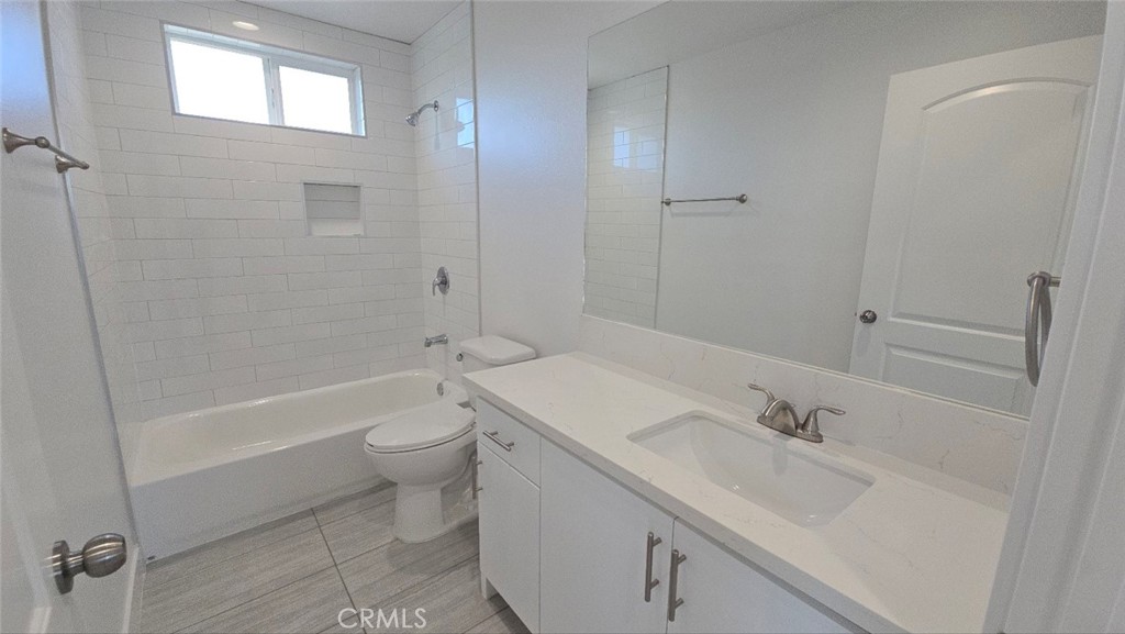 10413 Avalon Boulevard Los Angeles, CA 90003 - Photo 2 of 23 a bathroom with a sink a toilet and shower
