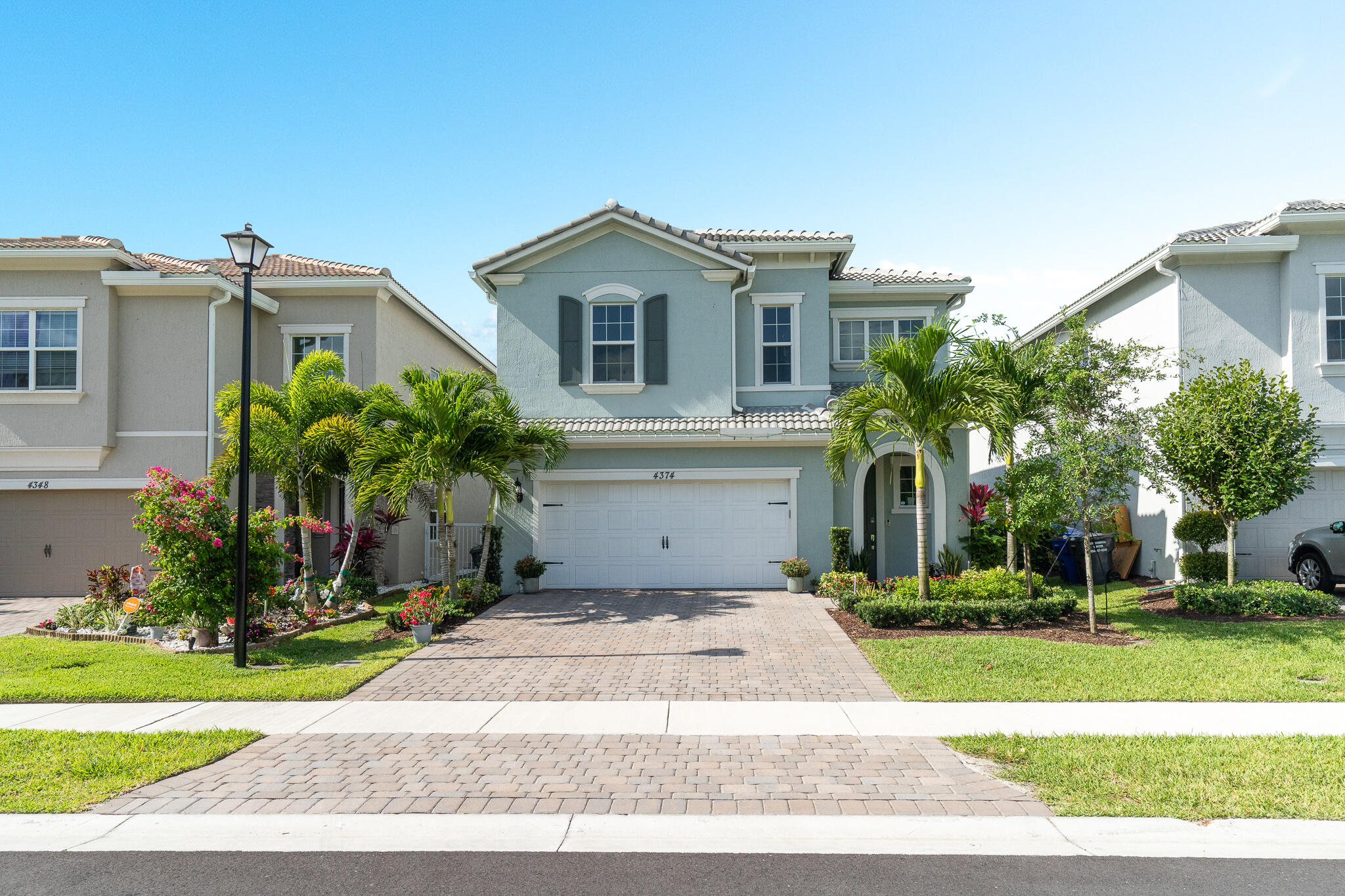 a front view of a house with a yard and a garage