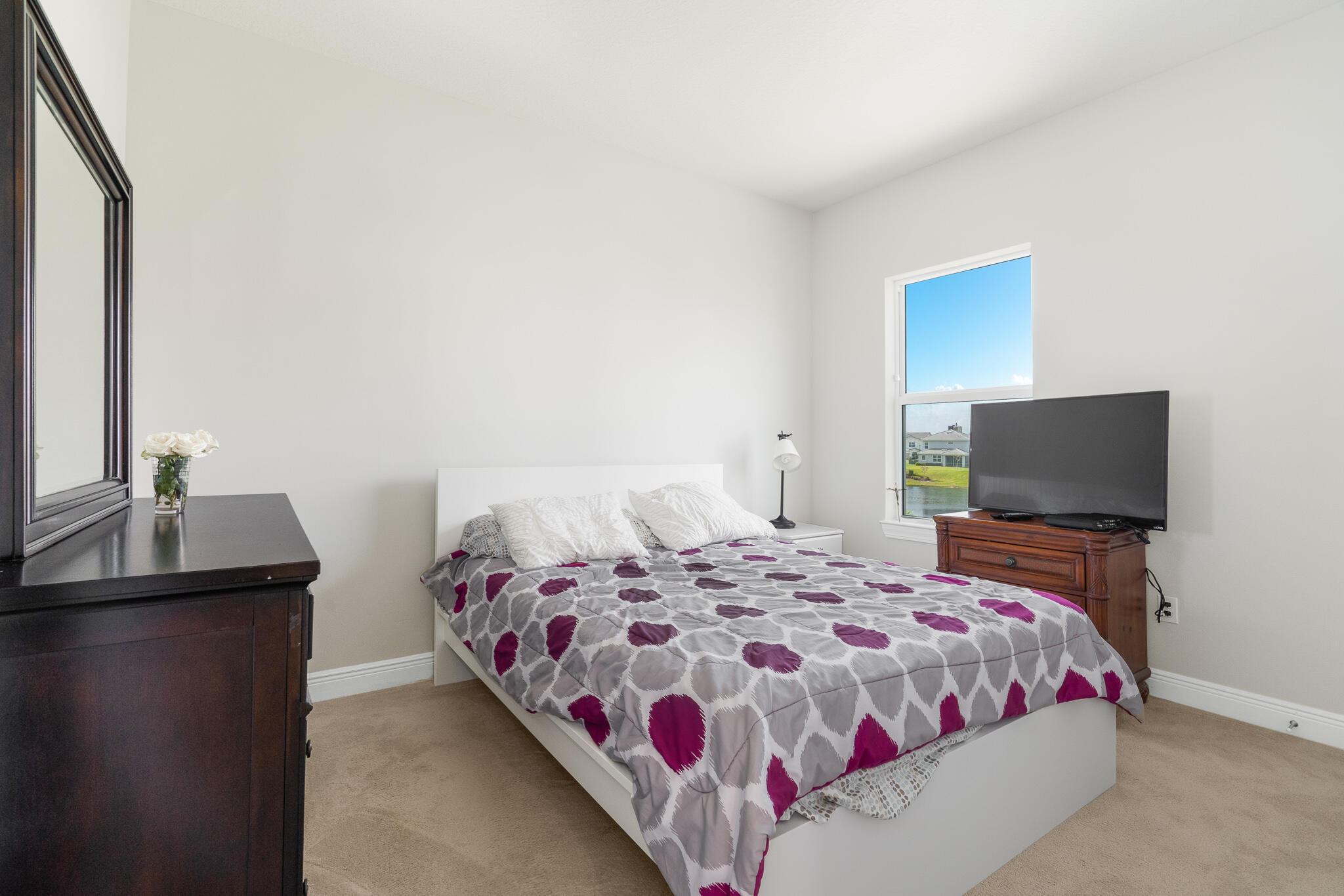 4374 Greenway Drive Hollywood, FL 33021 - Photo 28 of 46 a bedroom with a bed and a flat screen tv