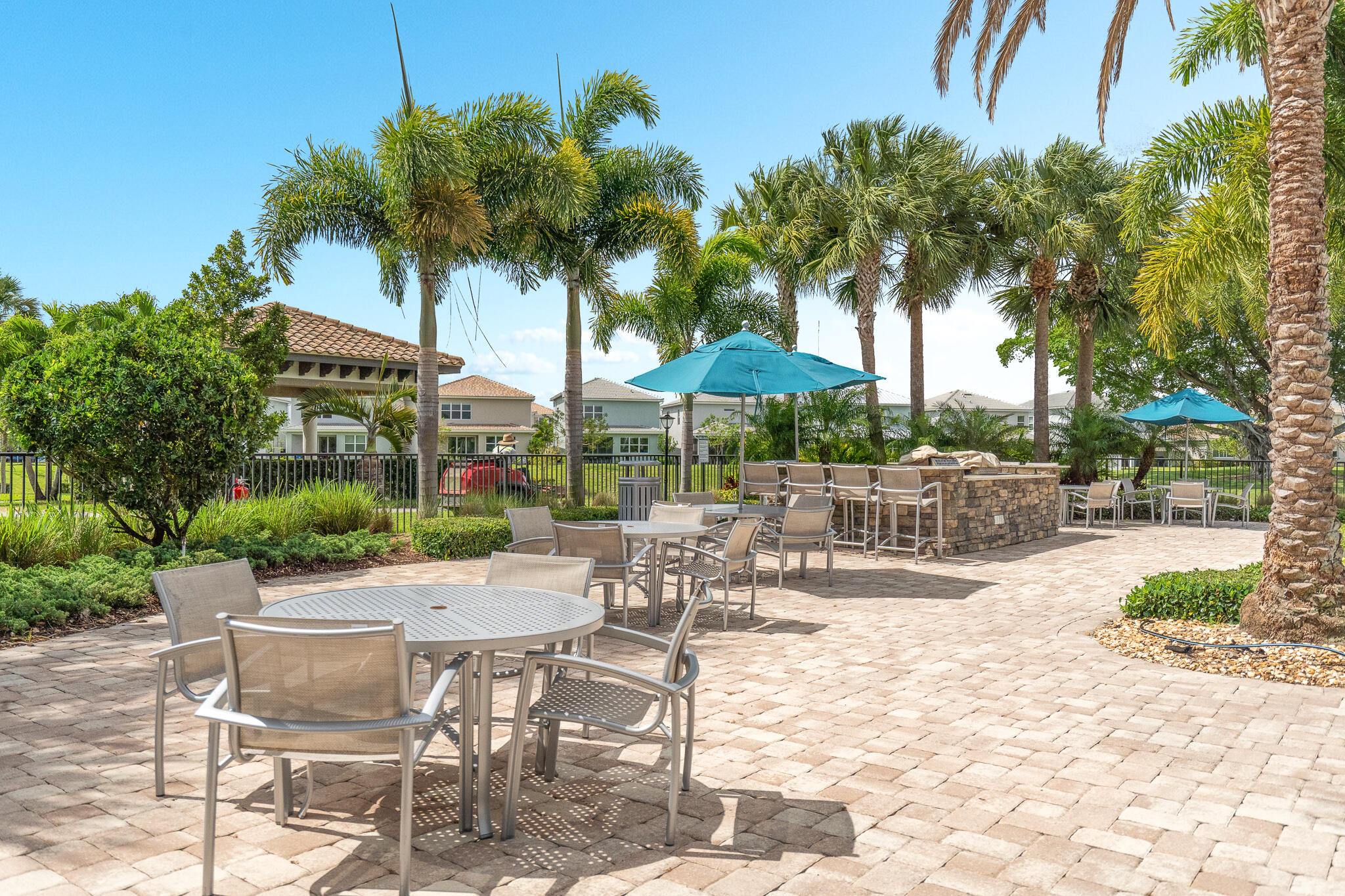 4374 Greenway Drive Hollywood, FL 33021 - Photo 42 of 46 a view of a patio with a table and chairs under an umbrella