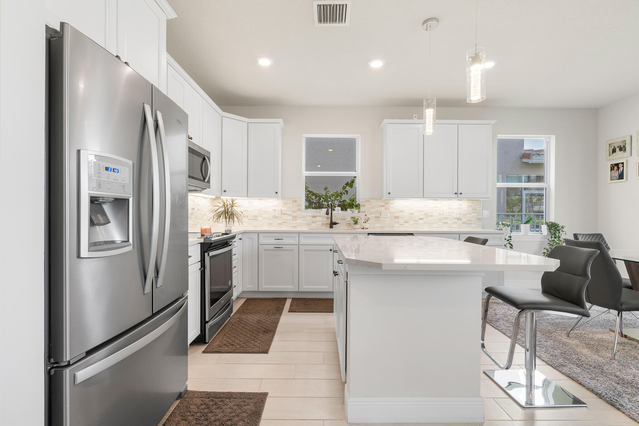 4374 Greenway Drive Hollywood, FL 33021 - Photo 9 of 46 a kitchen with white cabinets and stainless steel appliances