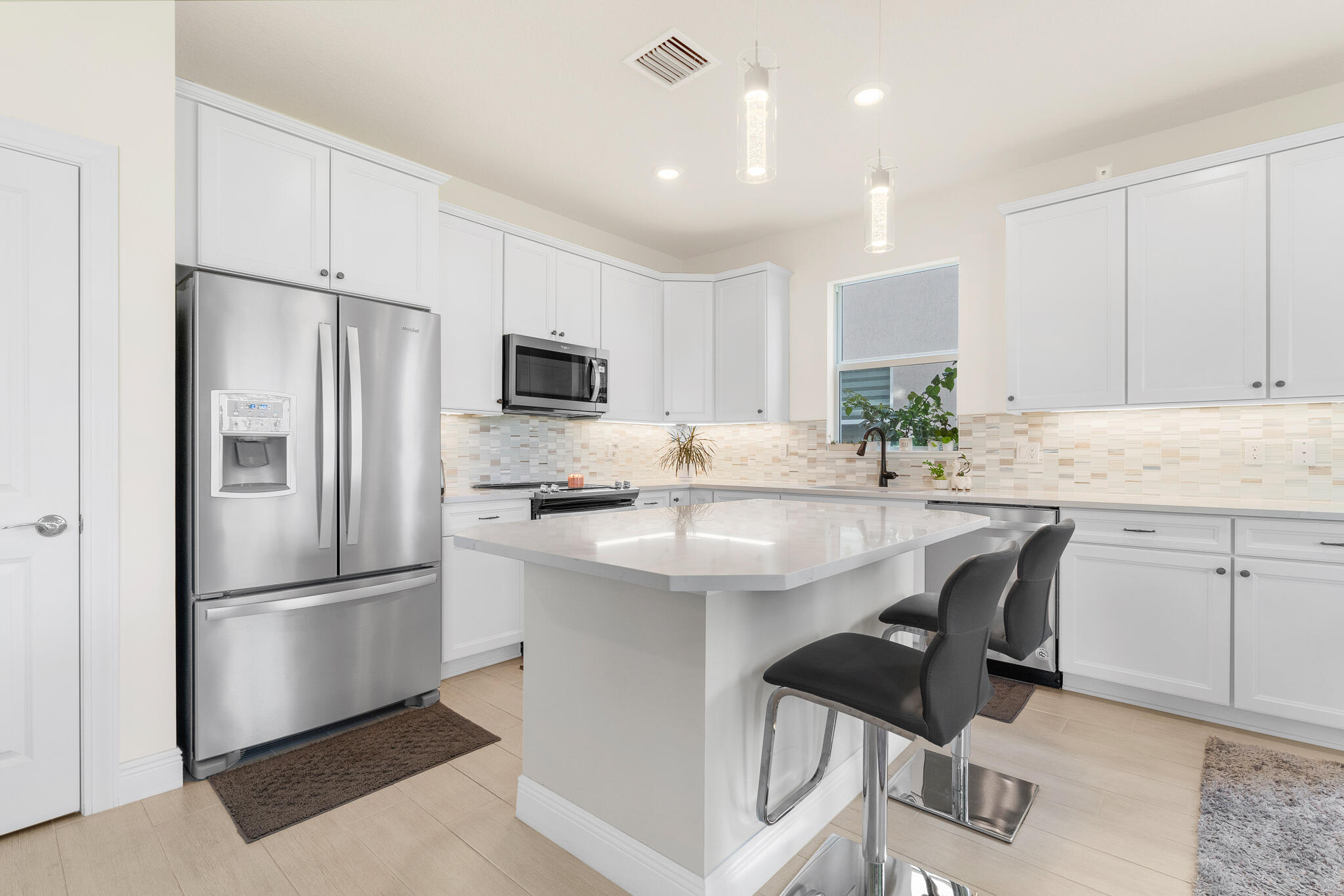 4374 Greenway Drive Hollywood, FL 33021 - Photo 10 of 46 a kitchen with kitchen island a counter top space appliances and cabinets