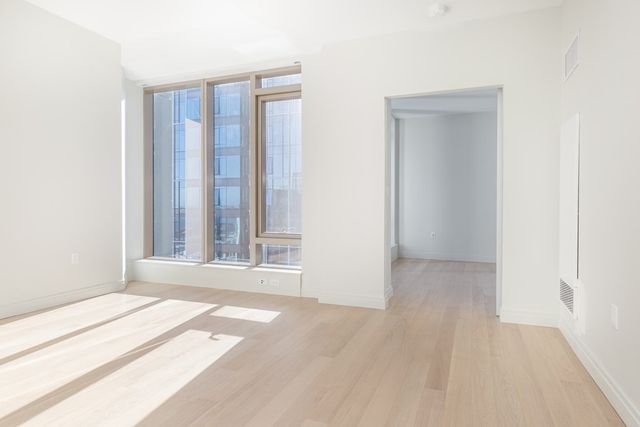 a bedroom with a large bed and a large window