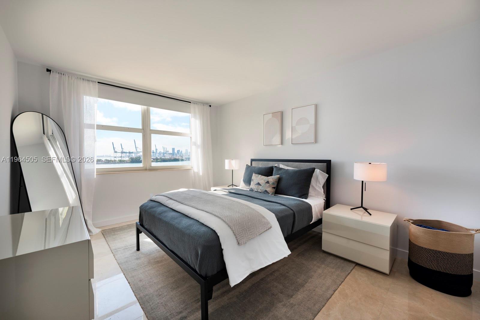 90 Alton Road, Unit 902 Miami Beach, FL 33139 - Photo 21 of 34 a bedroom with a bed couch and a window