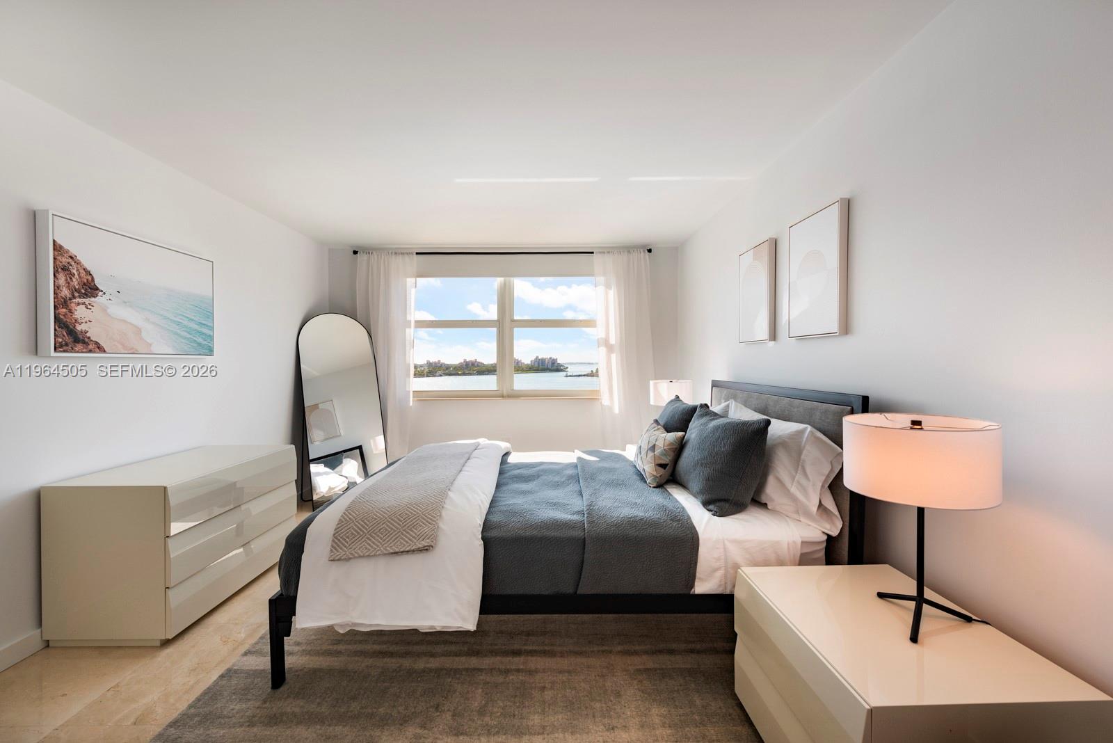 90 Alton Road, Unit 902 Miami Beach, FL 33139 - Photo 22 of 34 a bedroom with a bed and wooden floor