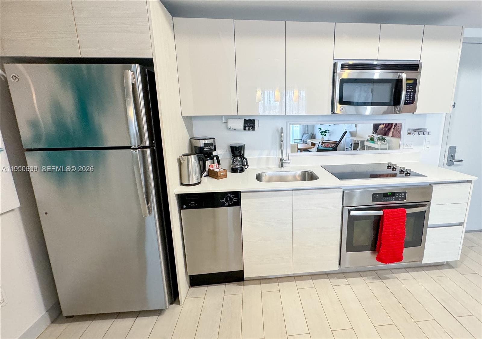 2602 East Hallandale Beach Boulevard, Unit R409 Hallandale Beach, FL 33009 - Photo 11 of 48 a utility room with cabinets washer and dryer