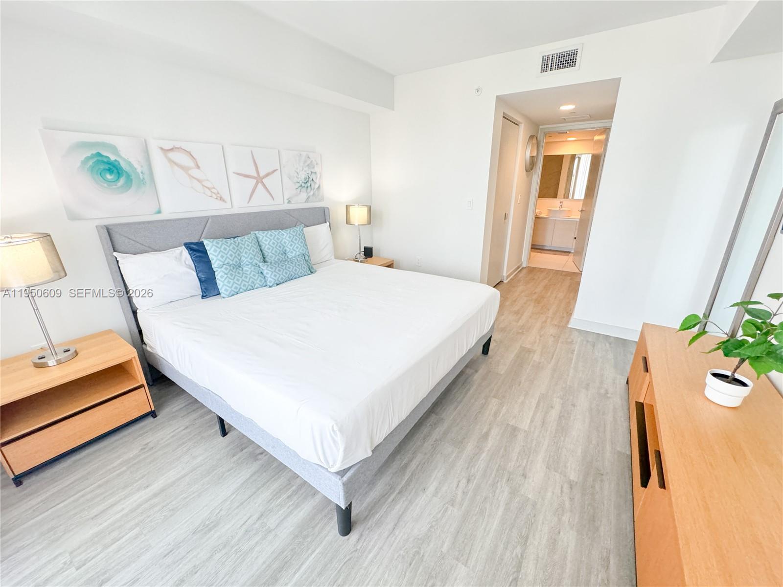 2602 East Hallandale Beach Boulevard, Unit R409 Hallandale Beach, FL 33009 - Photo 17 of 48 a large white bed in a white room