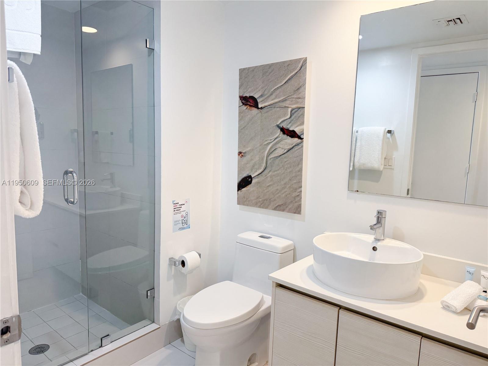 2602 East Hallandale Beach Boulevard, Unit R409 Hallandale Beach, FL 33009 - Photo 22 of 48 a bathroom with a sink toilet and shower