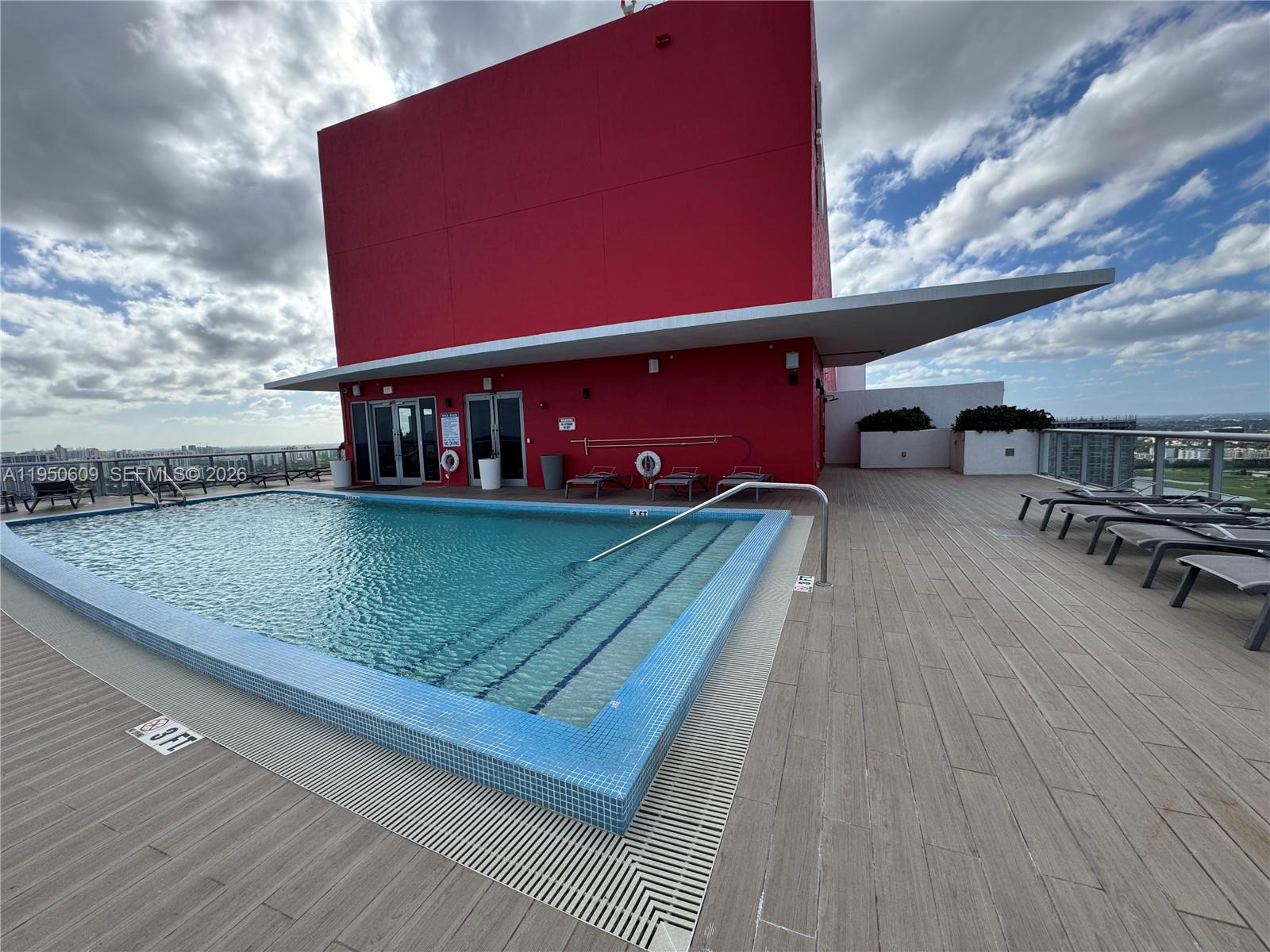2602 East Hallandale Beach Boulevard, Unit R409 Hallandale Beach, FL 33009 - Photo 32 of 48 a view of a pool with a yard