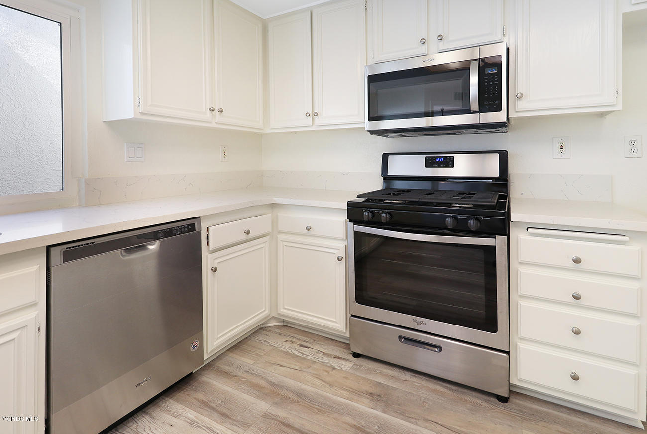 851 Congressional Road Simi Valley, CA 93065 - Photo 11 of 28 a kitchen with cabinets stainless steel appliances and a wooden floor